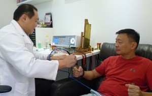Therapist doing bioresonance treatment for patient